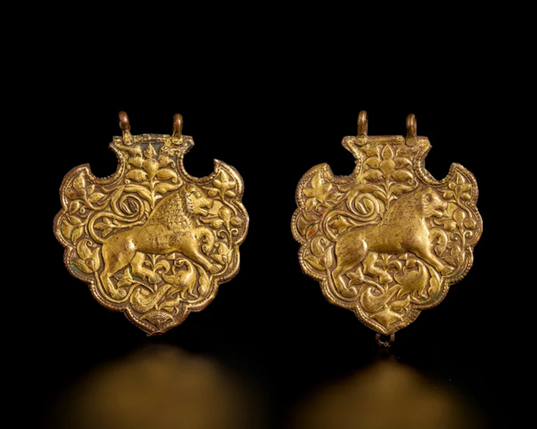 Two repousse gilt copper hanging lobed ornaments