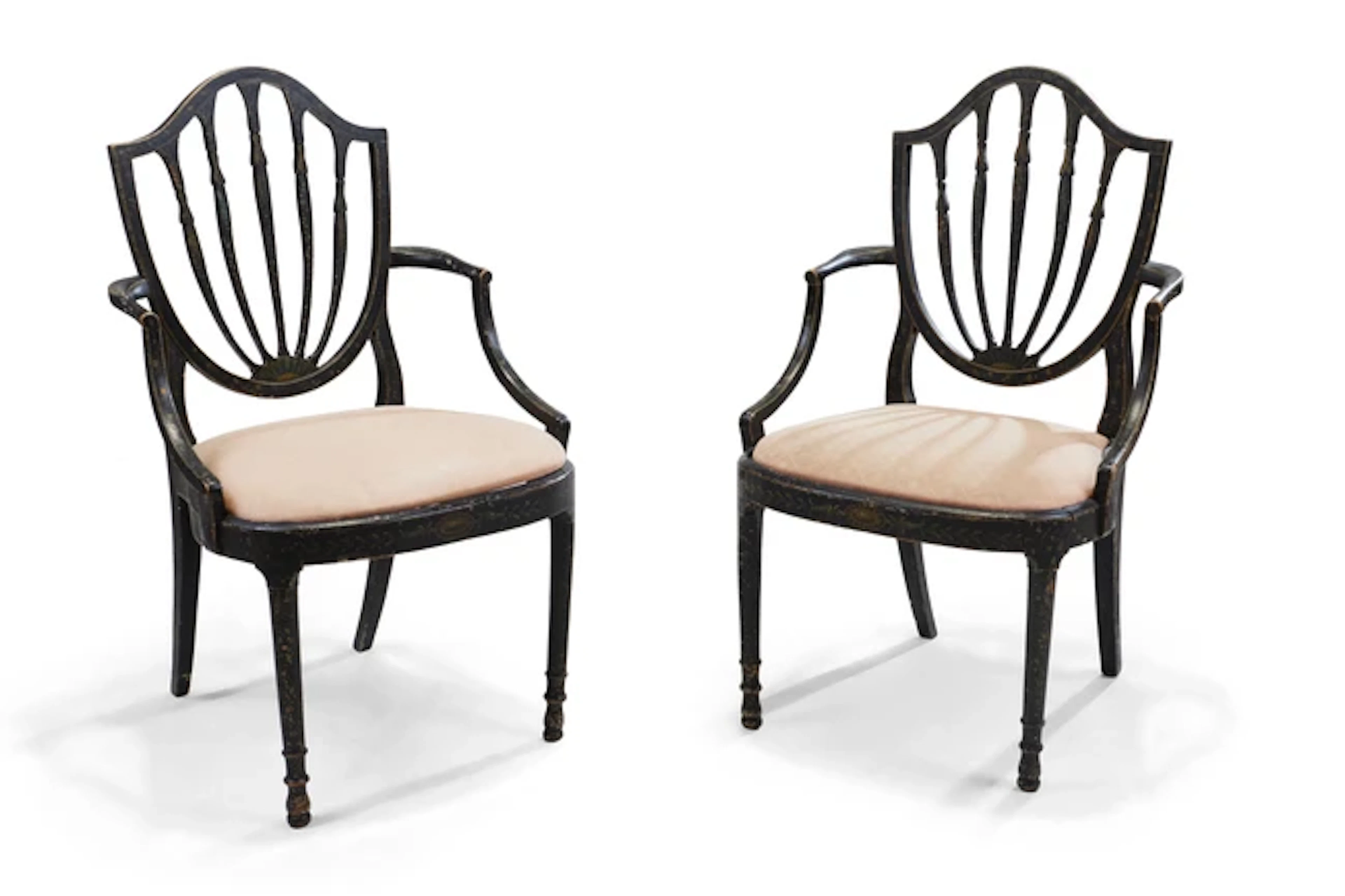 A pair of George III painted and ebonised open elbow chairs