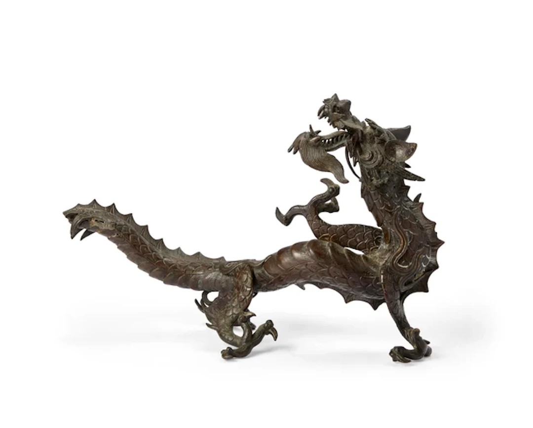 A Japanese bronze okimono of a dragon Meiji period The...