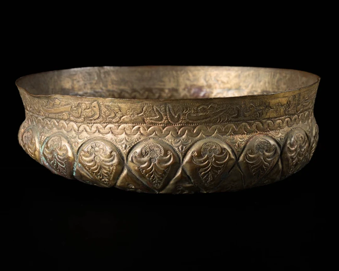 An inscribed Ottoman gilt copper (tombak) hammam bowl