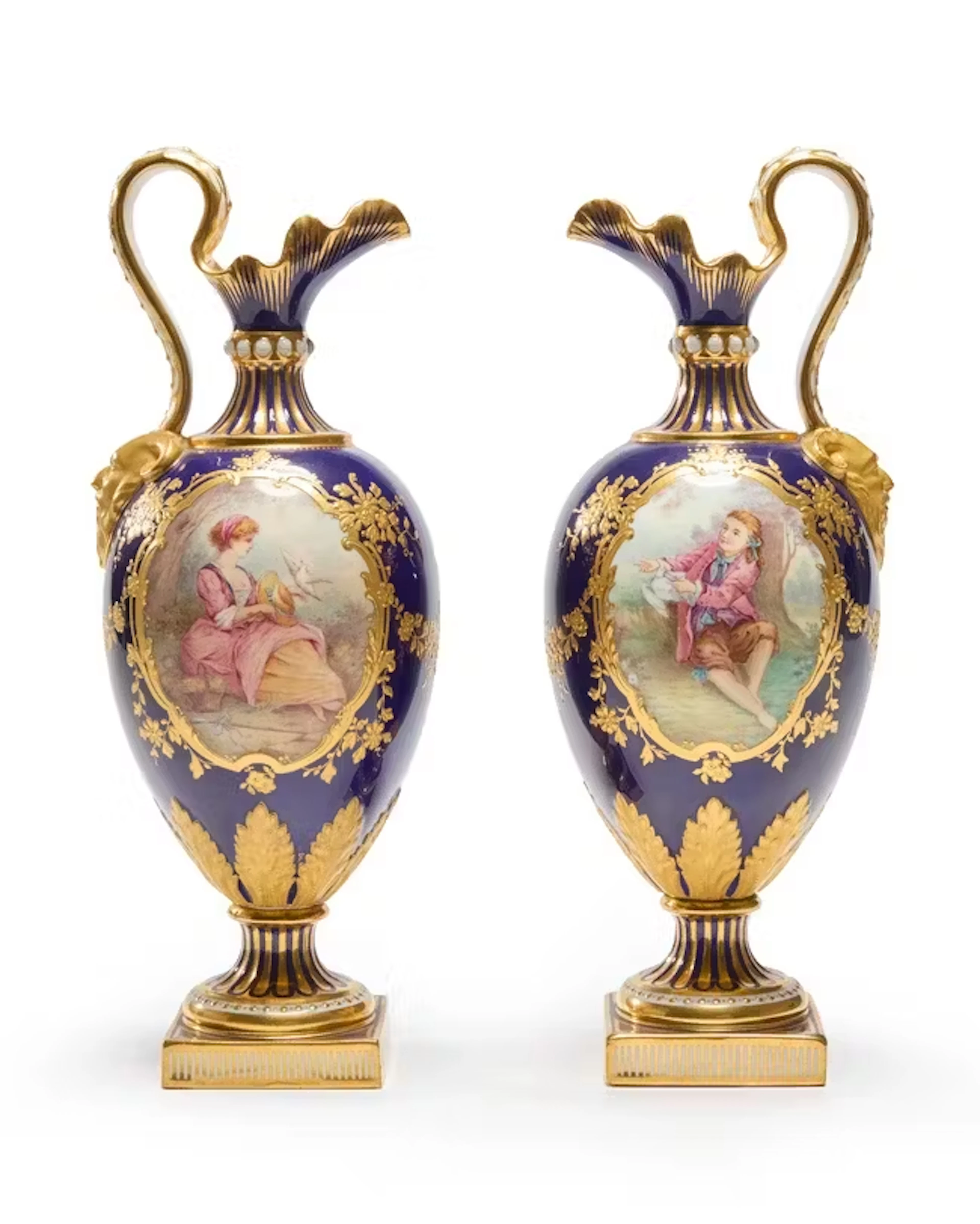 A pair of Minton porcelain Sèvres-style bleu de Roi ground ewers