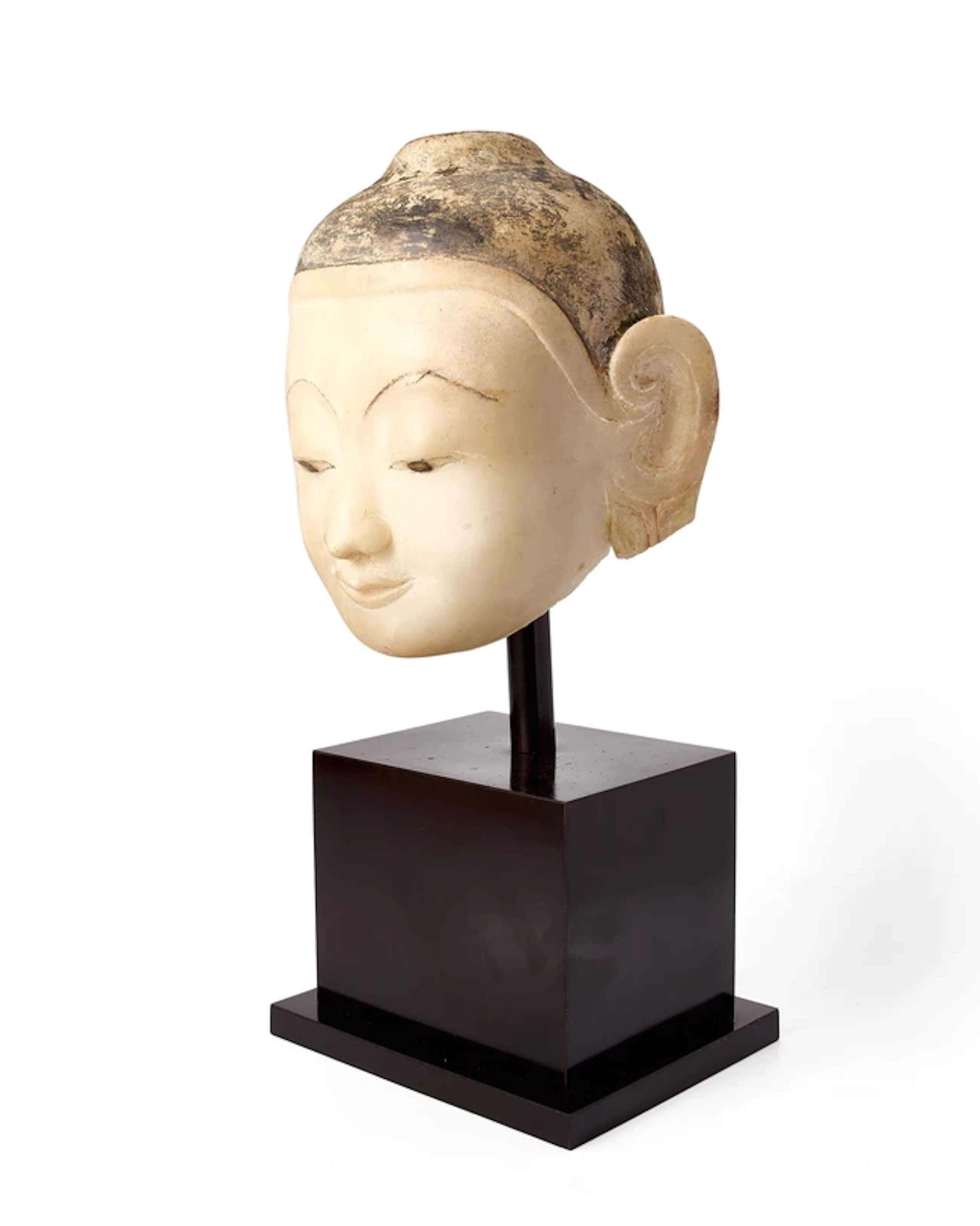 A Burmese painted marble head of Buddha 18th/19th century...