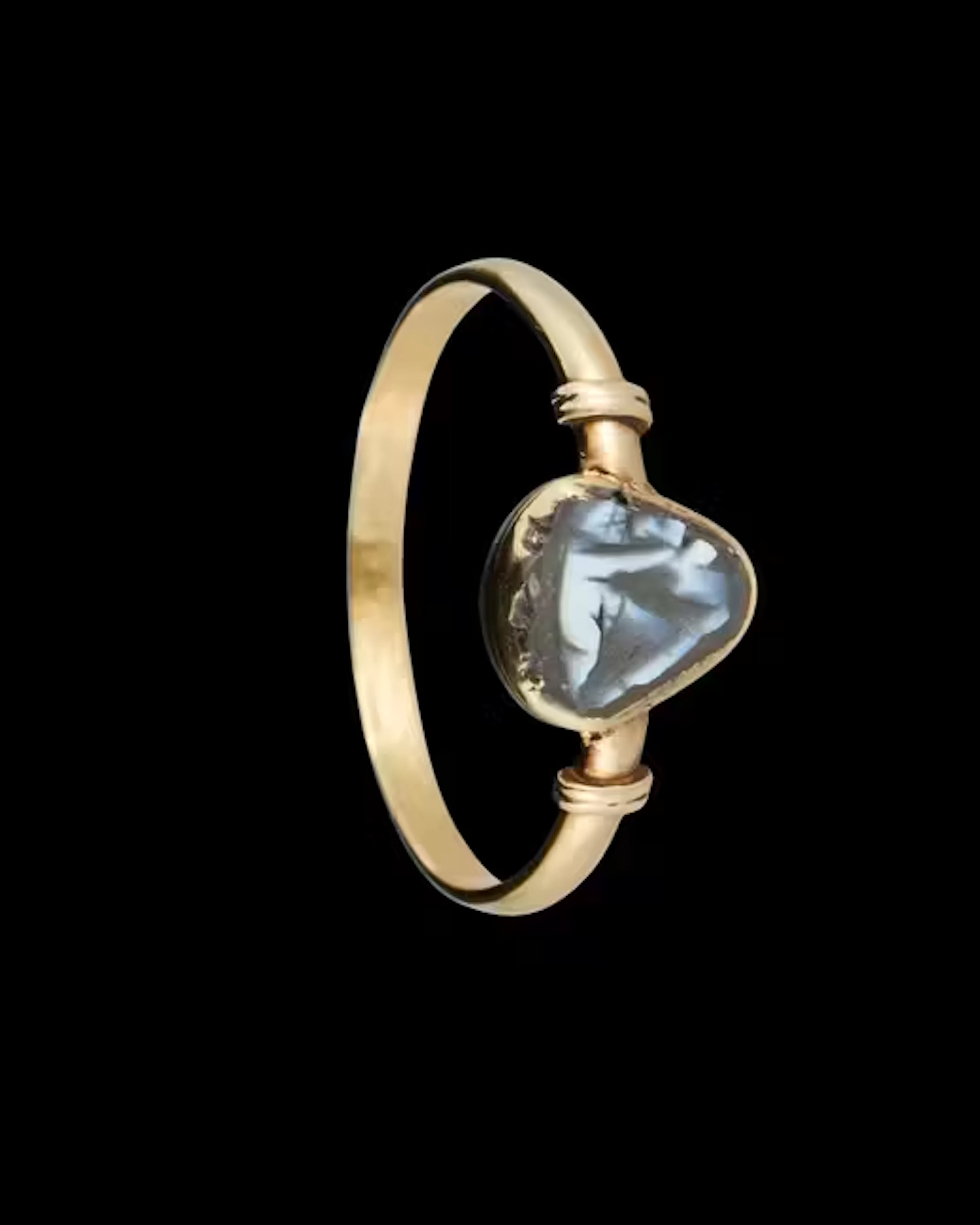 A Roman onyx cameo of Eros set in an antique gold...