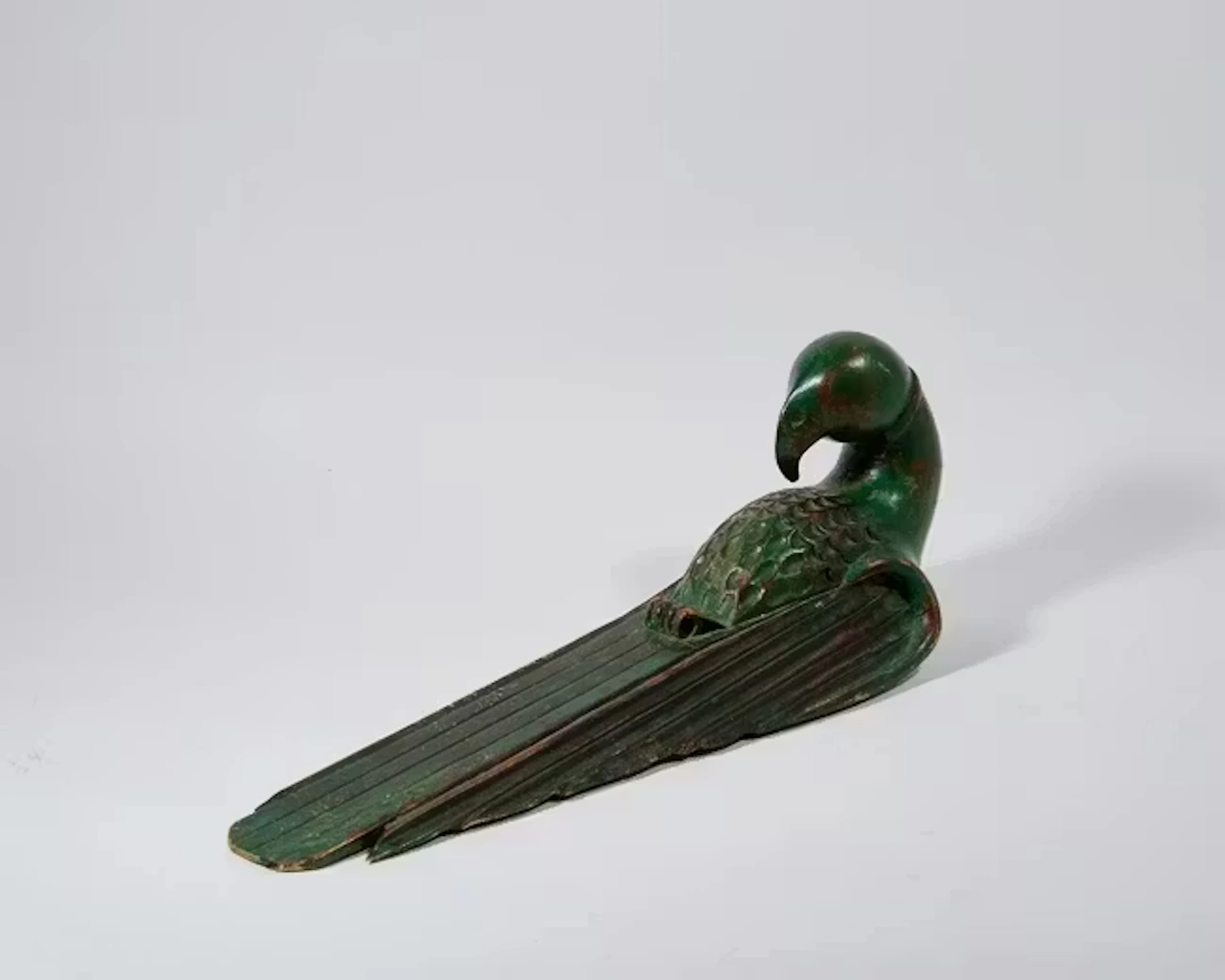 A large carved wall-hanging sculpture of a macaw
