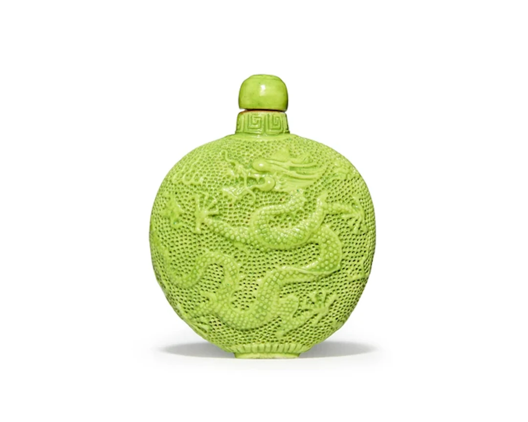 A Chinese lime-green enamelled moulded 'dragon' snuff...