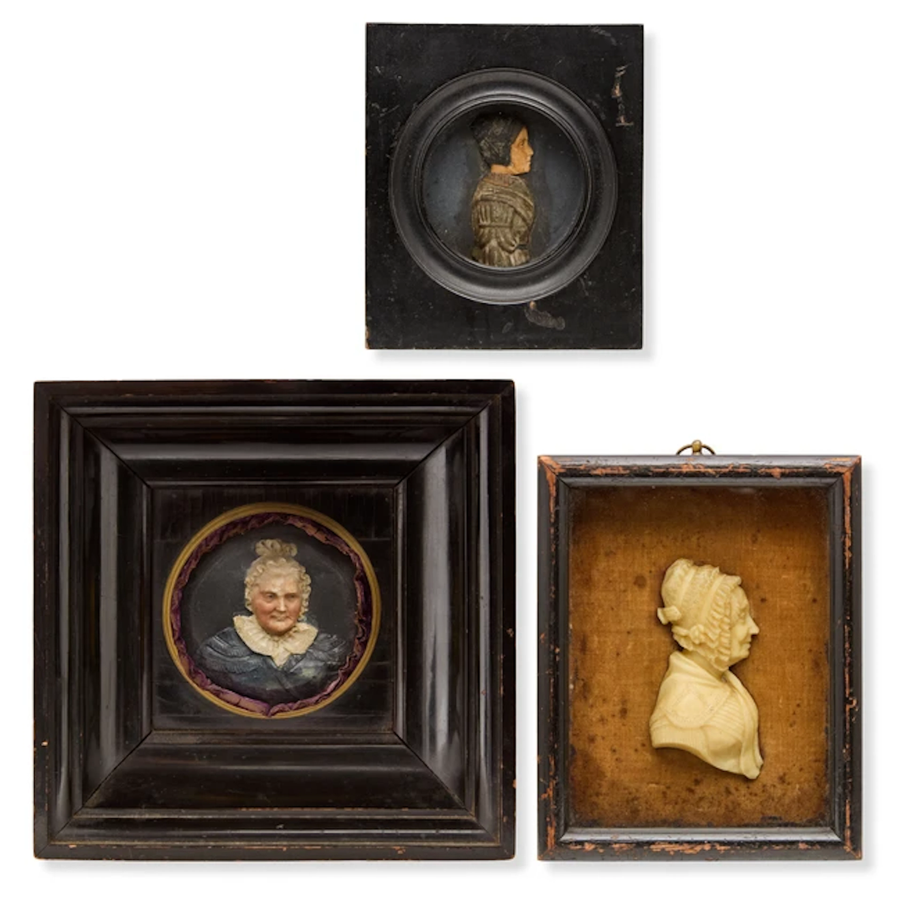 Three wax portrait reliefs of older ladies in bonnets