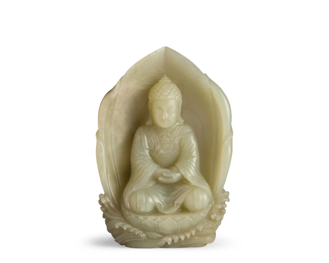 A Chinese pale jade carved figure of a seated Buddha Qing dynasty