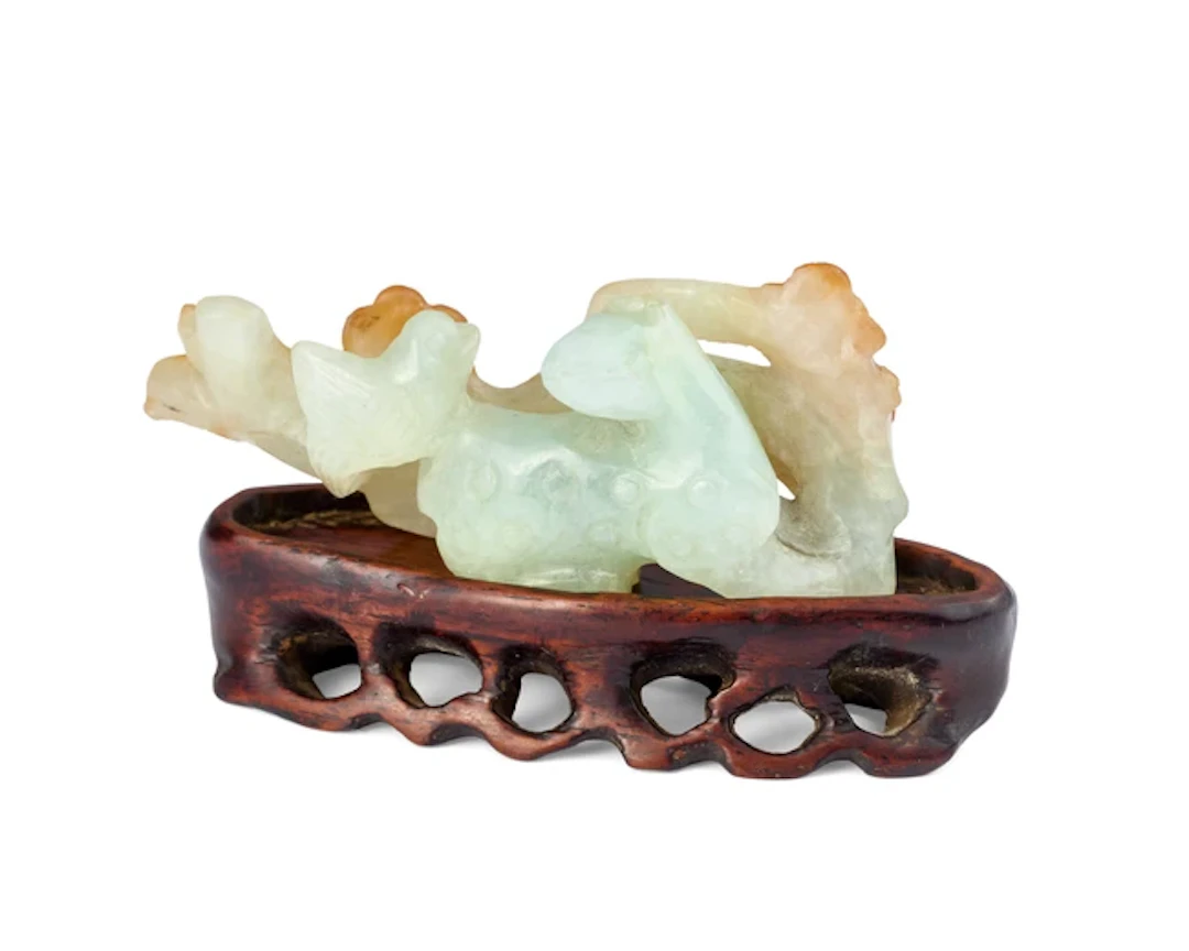 A Chinese jadeite 'deer and prunus' brush rest Qing dynasty