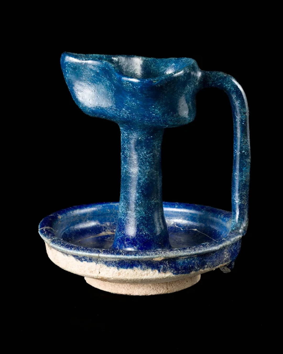 A cobalt blue glazed pottery oil lamp
