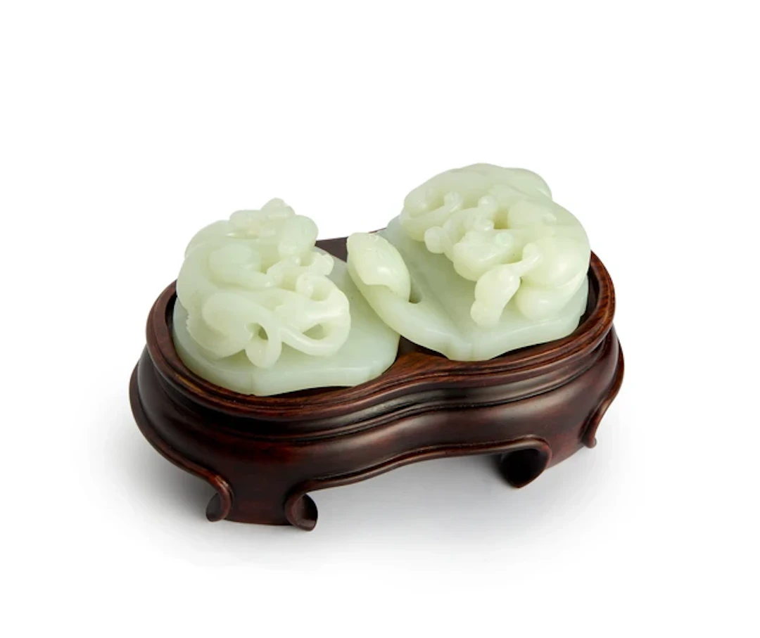 A Chinese pale green jade two-part 'dragon' belt buckle...