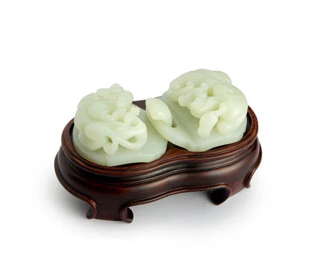 A Chinese pale green jade two-part 'dragon' belt buckle...