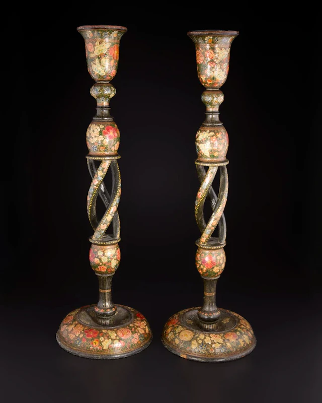 A pair of lacquered candlesticks
