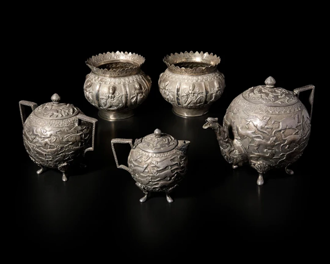 An Indian silver repoussé three-piece tea set