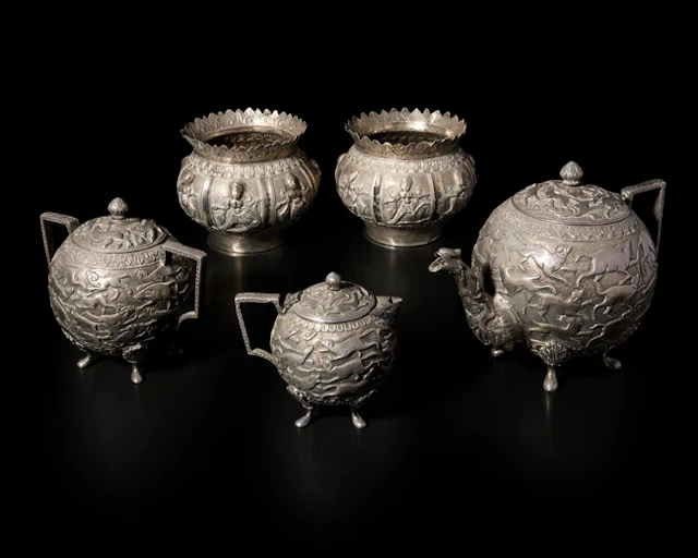An Indian silver repoussé three-piece tea set