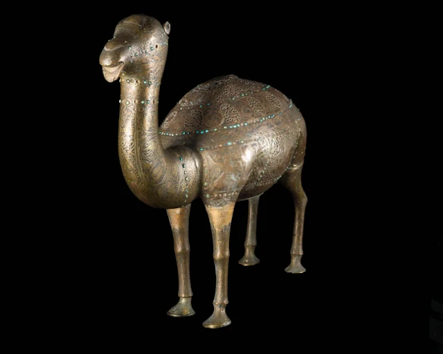 A Qajar openwork turquoise-inlaid camel
