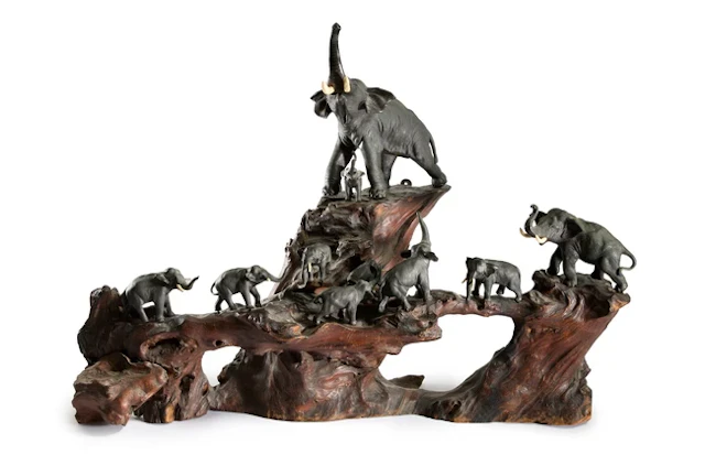 A Japanese bronze okimono group of elephants with fitted...