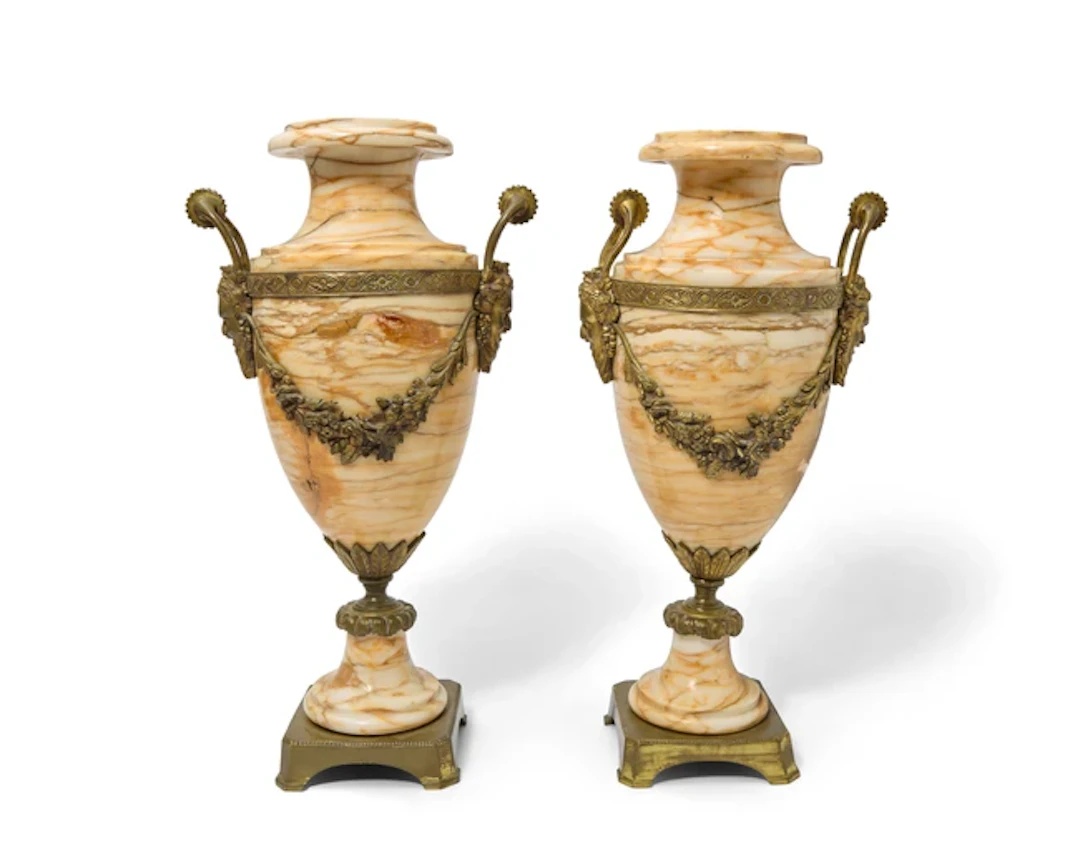A pair of gilt-bronze mounted marble urns