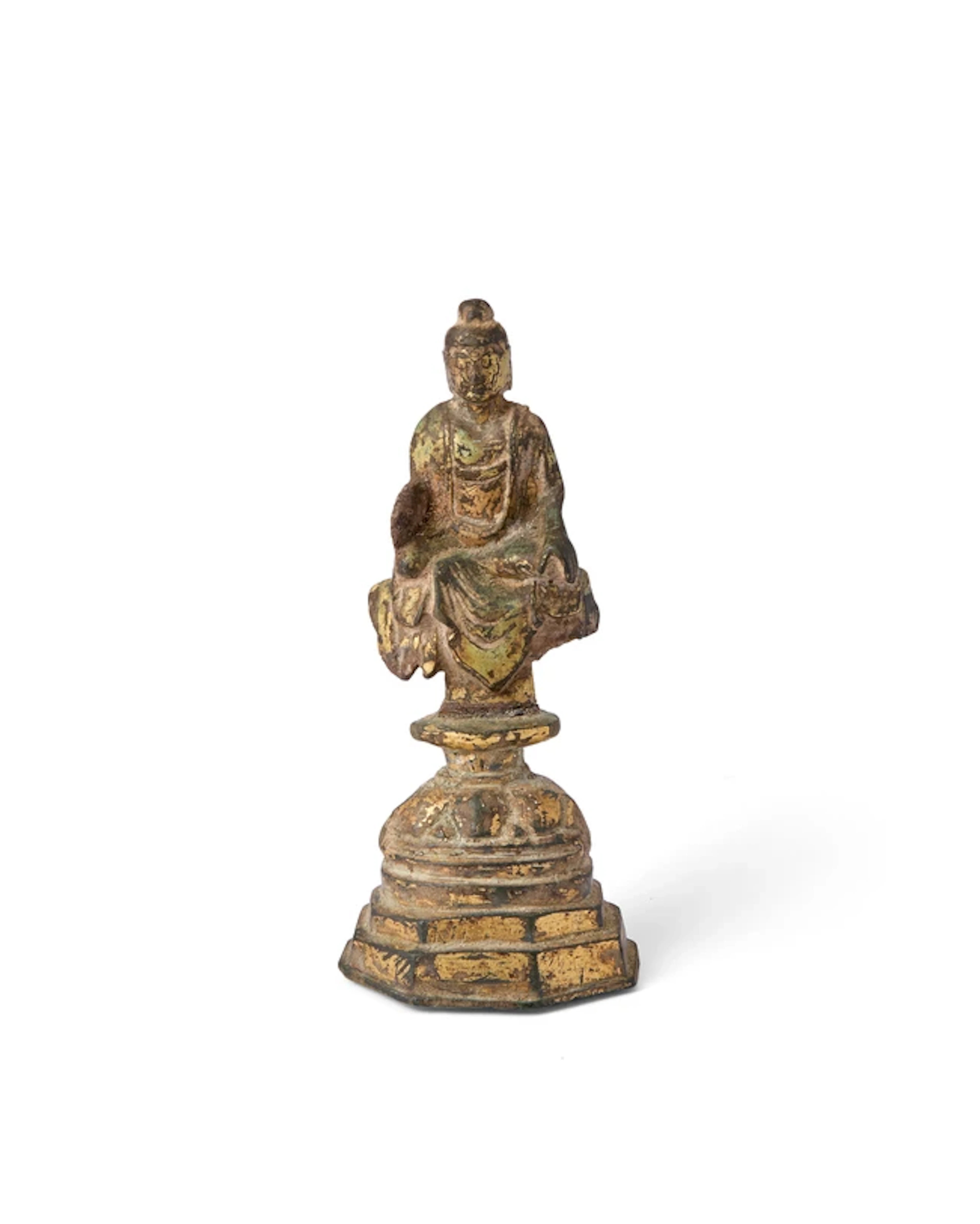 A small Chinese gilt-bronze figure of a seated Buddha on...