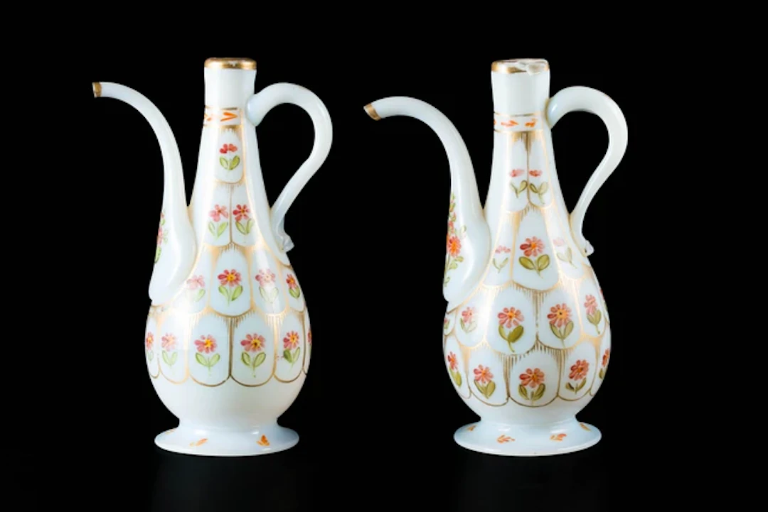 A pair of pyriform Beykoz opaline glass ewers