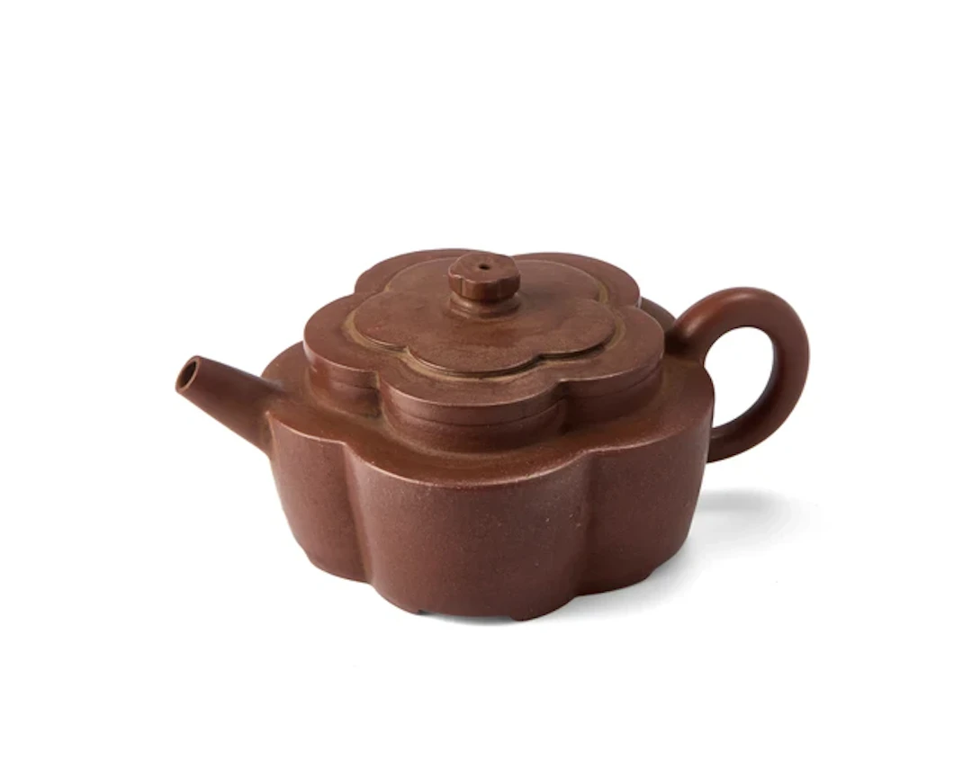 A Chinese Yixing 'plum' teapot Late 20th century Rising from four bracket feet