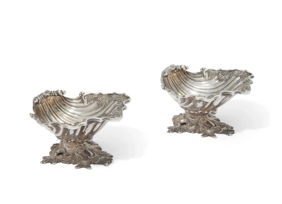 A pair of Elizabeth II silver shell form salt cellars