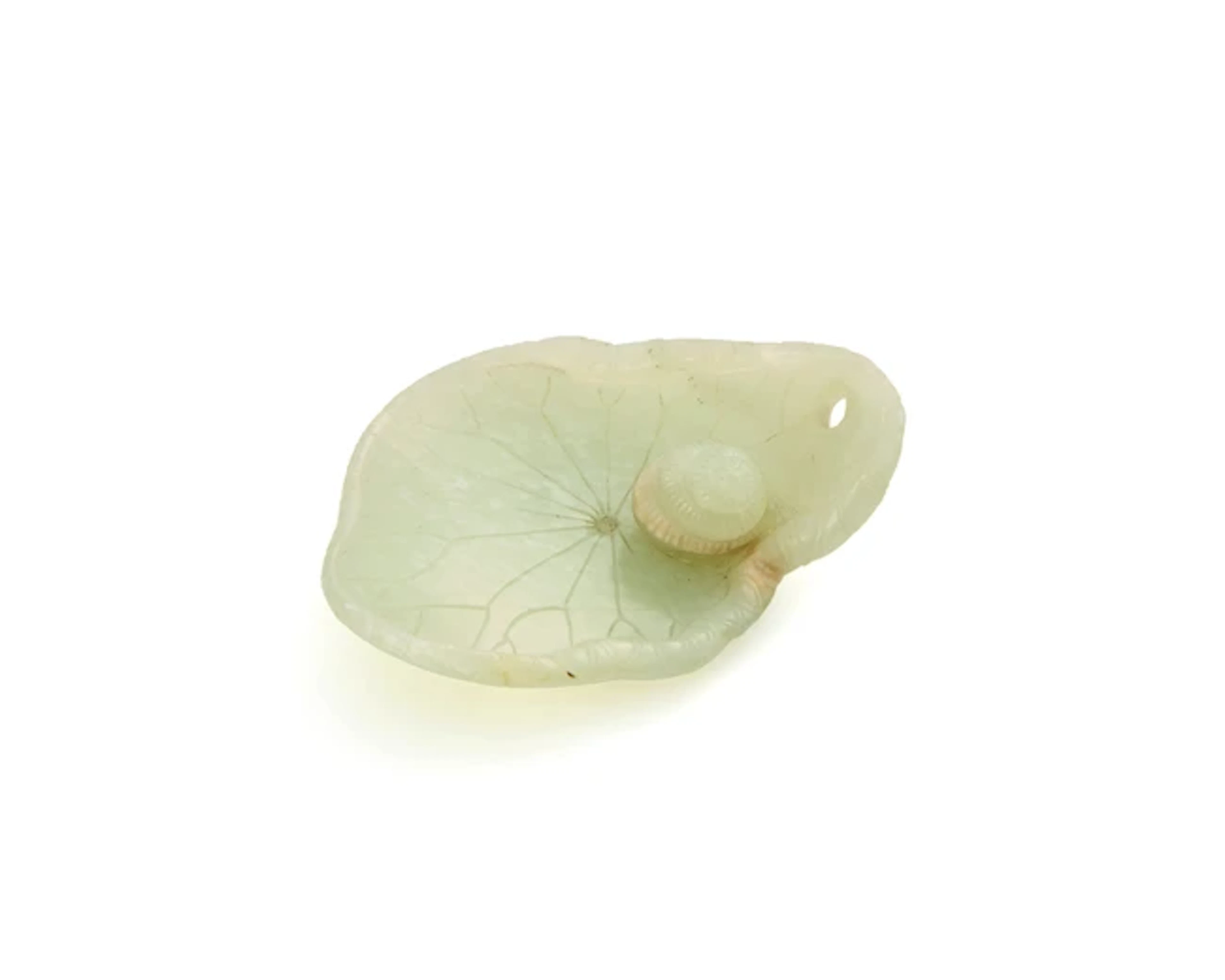 A Chinese pale green jade carving of a snail on a lotus leaf Qing dynasty
