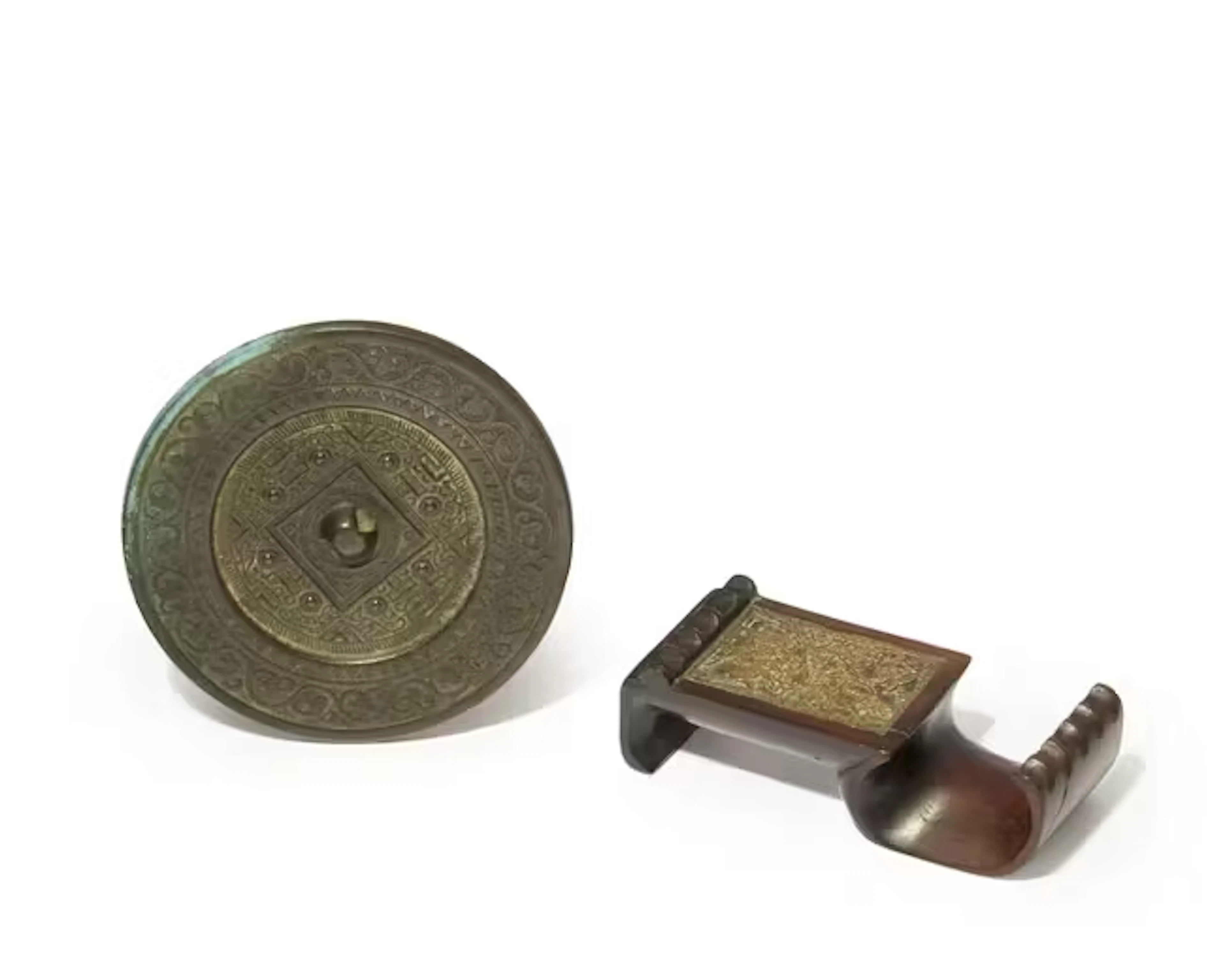 A Chinese 'TLV' mirror and a hardwood brush rest Ming...