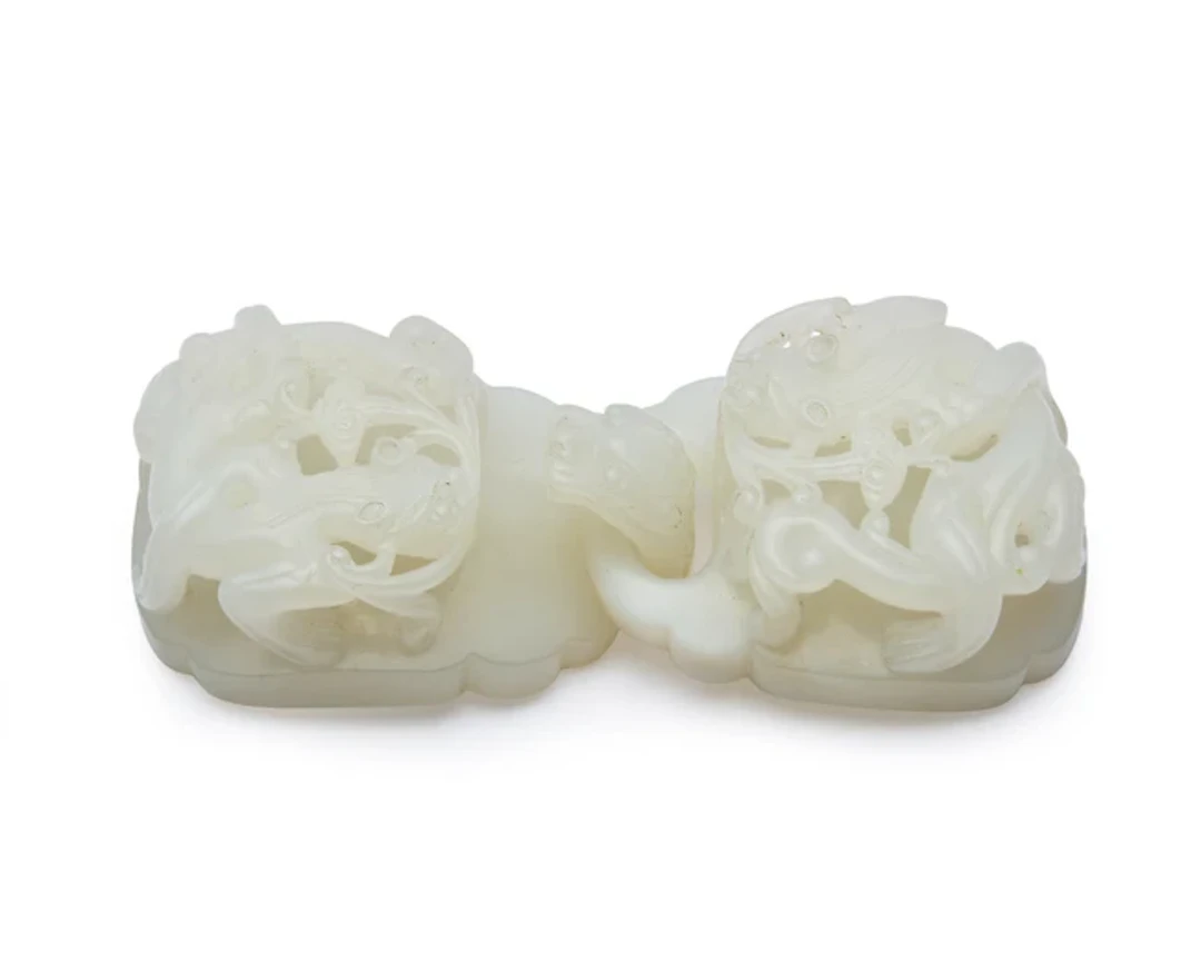 A Chinese white jade belt buckle and hook Late Qing dynasty The pale
