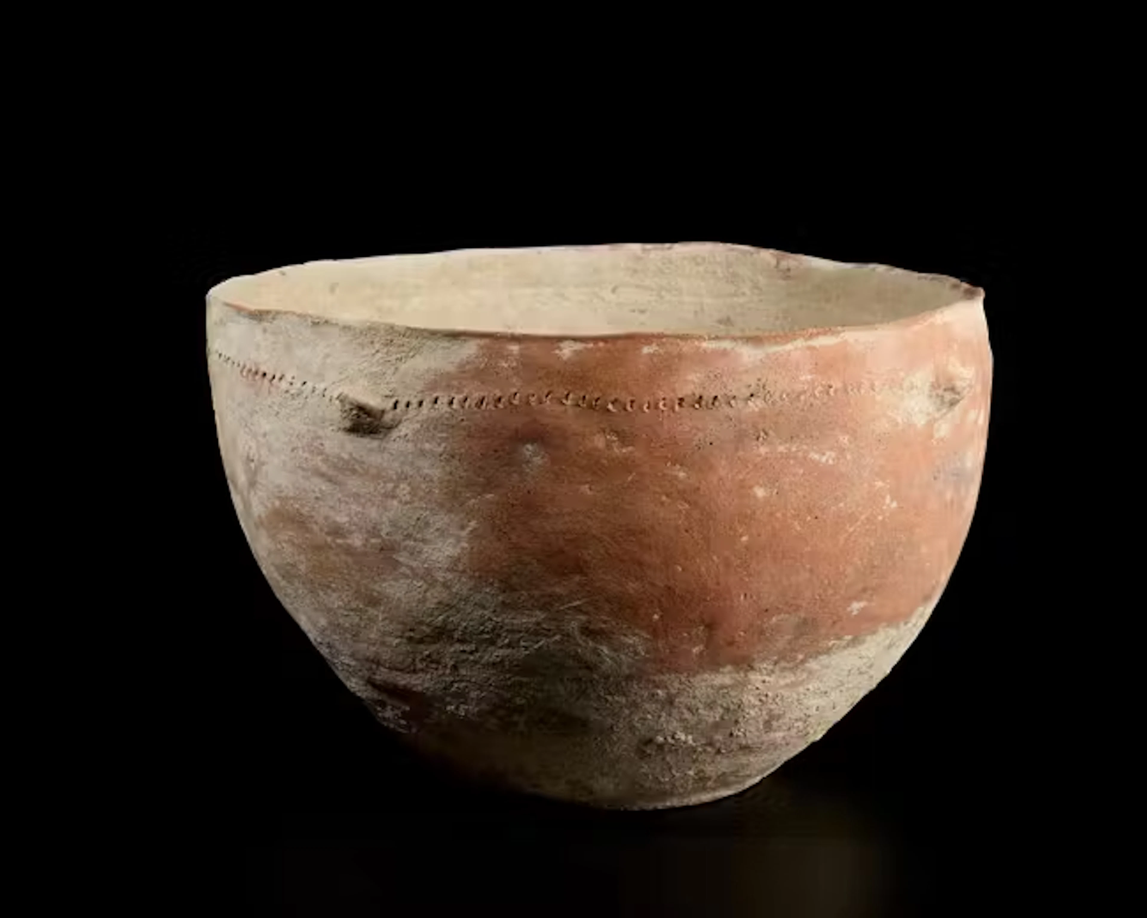 A large unglazed pottery bowl