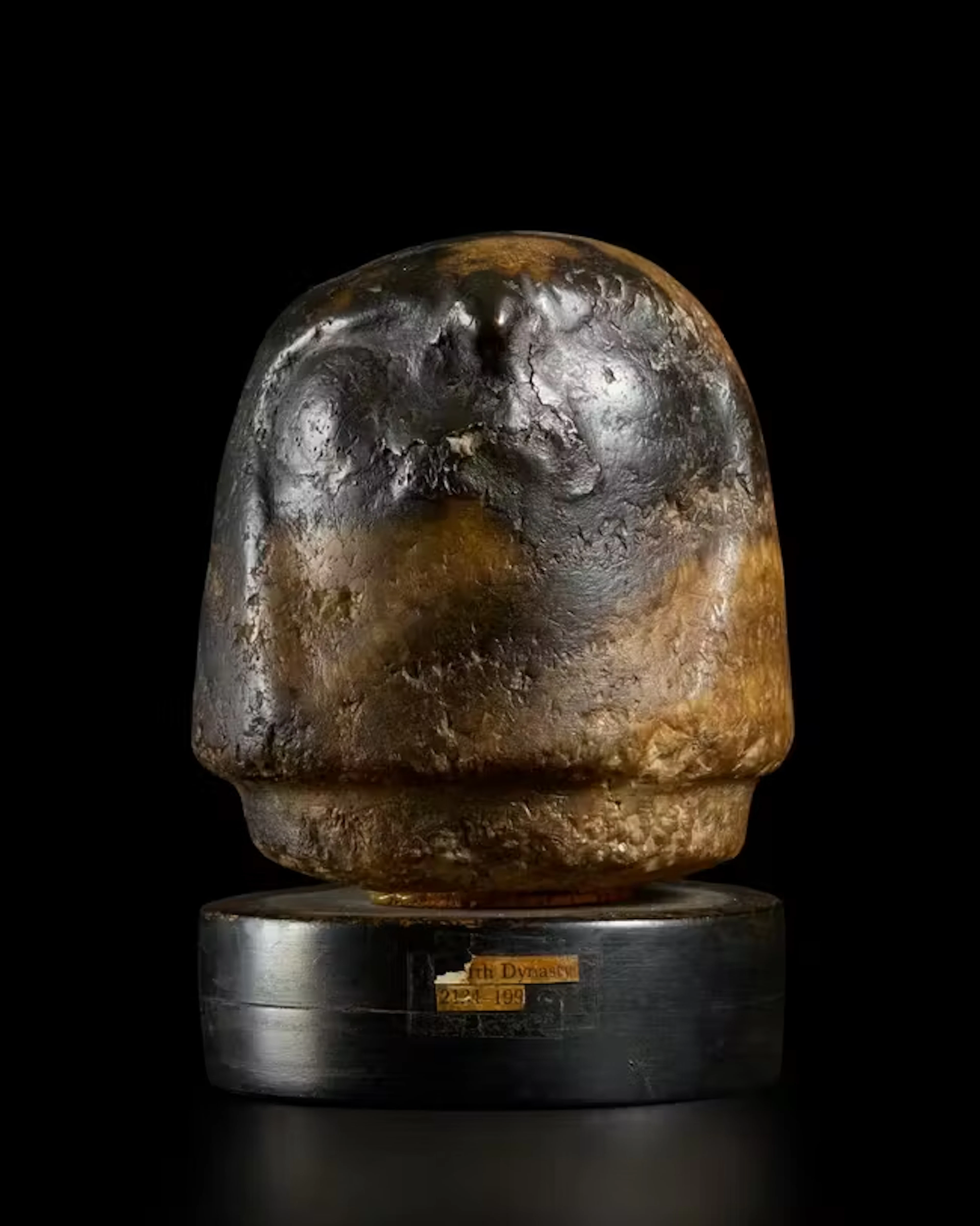 An Egyptian alabaster canopic jar stopper Late Period