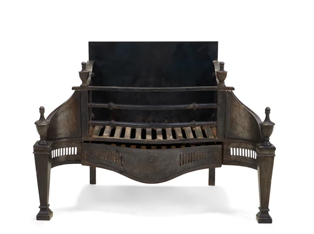 A Victorian cast-iron and engraved steel fire grate