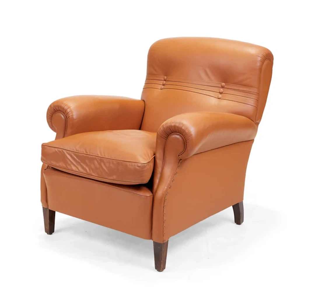 A tan leather club armchair