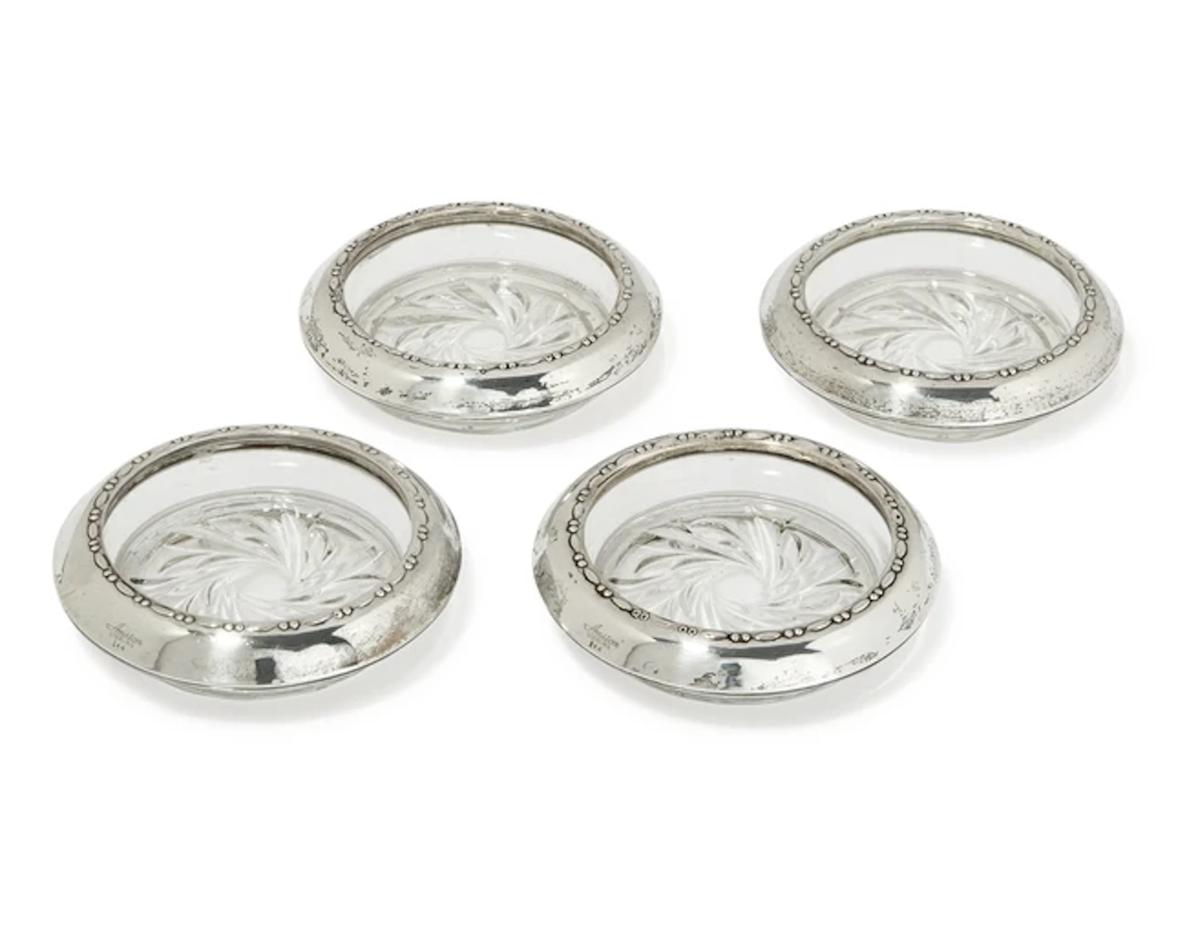 A set of four American silver-mounted glass coasters