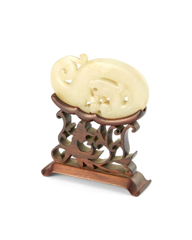 A Chinese pale grey jade reticulated 'chilong' carving...