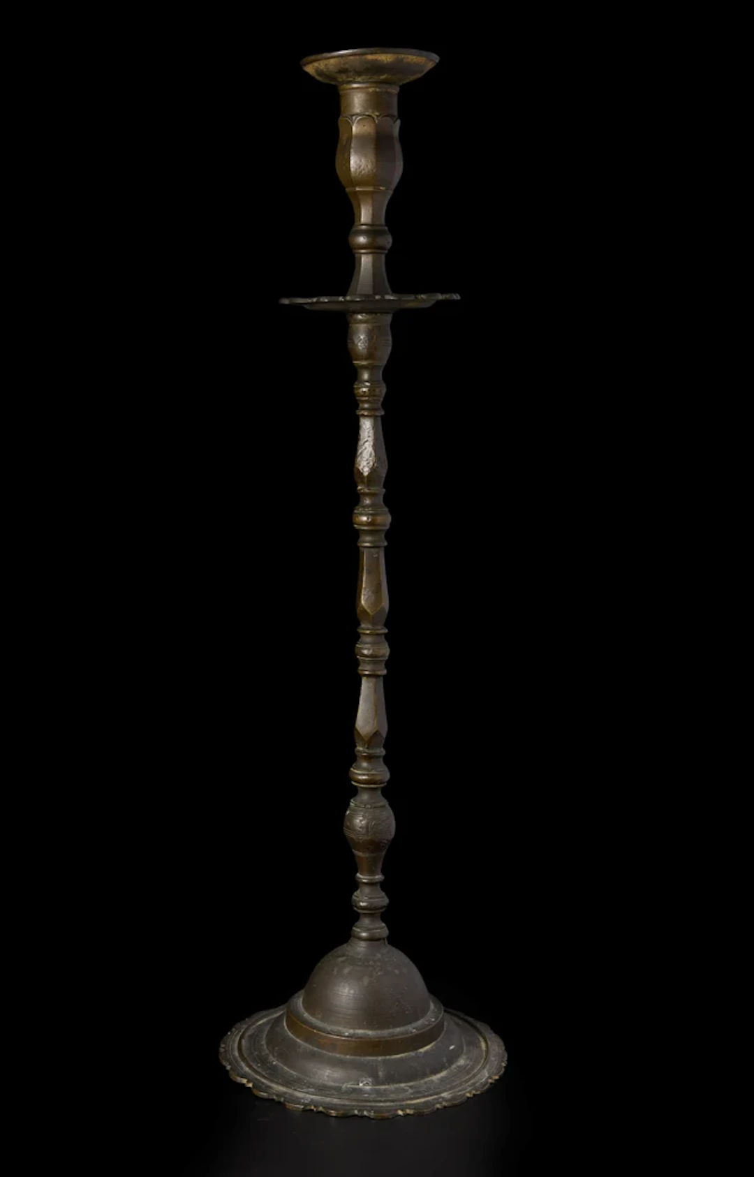 An associated tall copper alloy candlestick