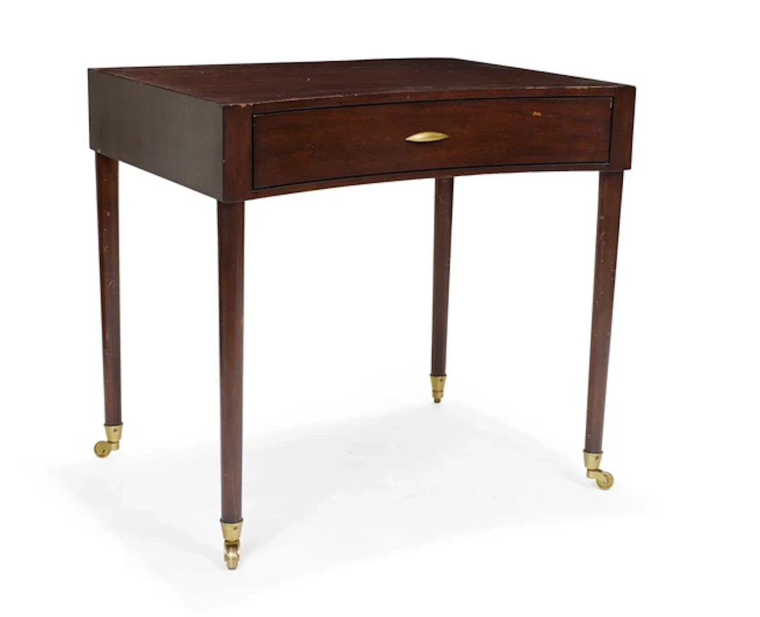 A modern mahogany concave front writing table
