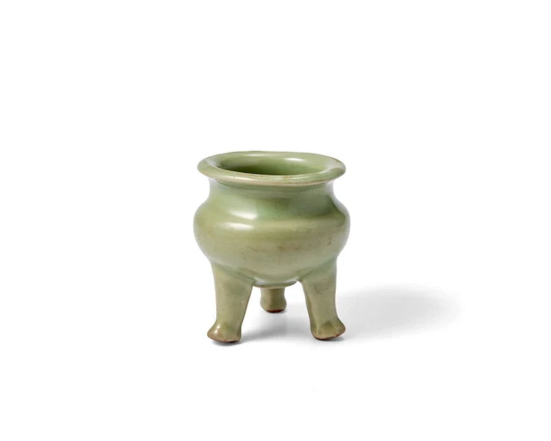 A Chinese celadon glazed tripod incense burner Ming...