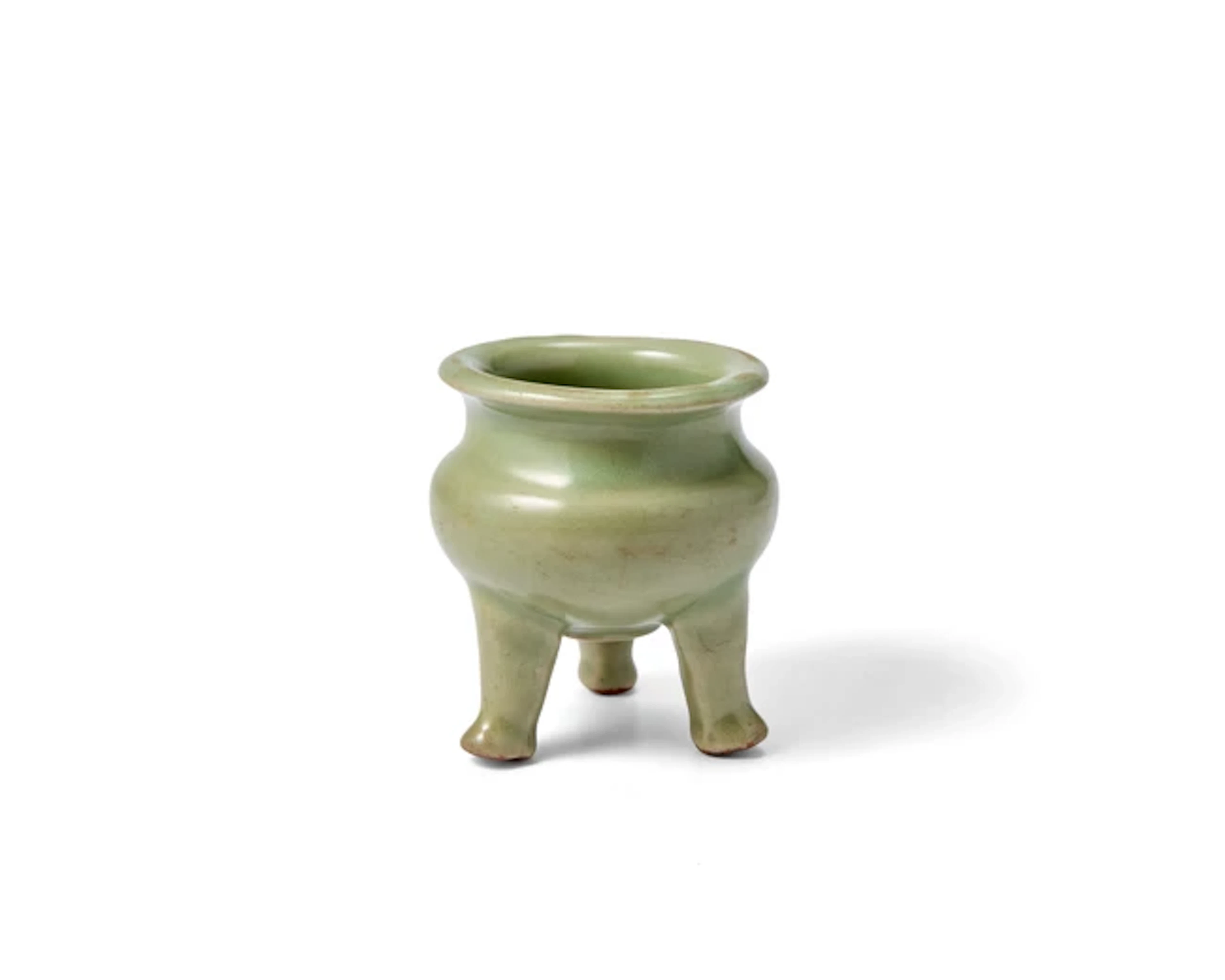 A Chinese celadon glazed tripod incense burner Ming...