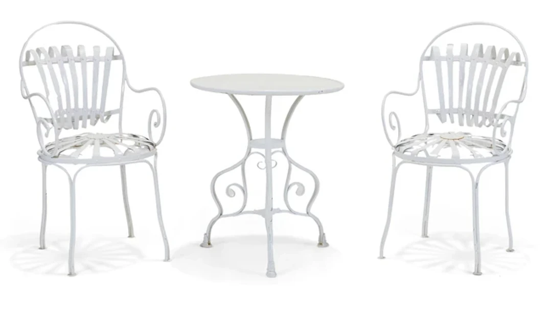 A pair of modern white-painted iron sprung bistro chairs