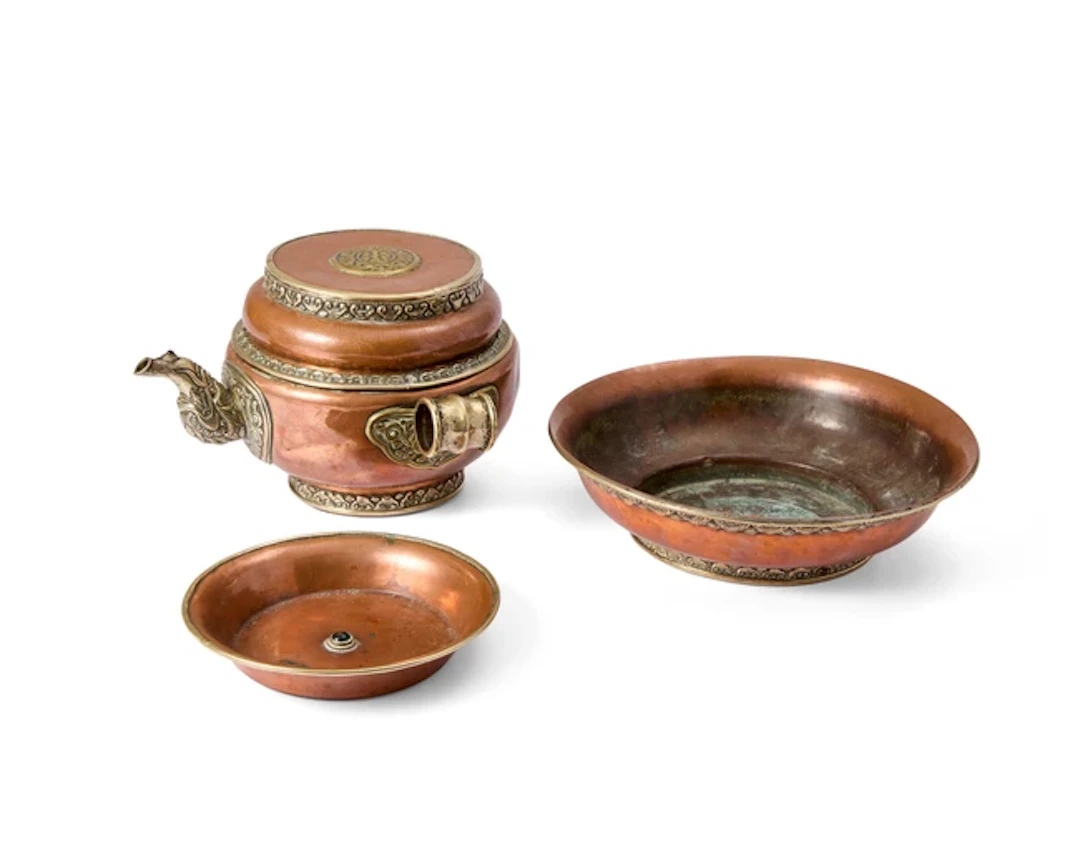 A Tibetan copper repoussé water offering set