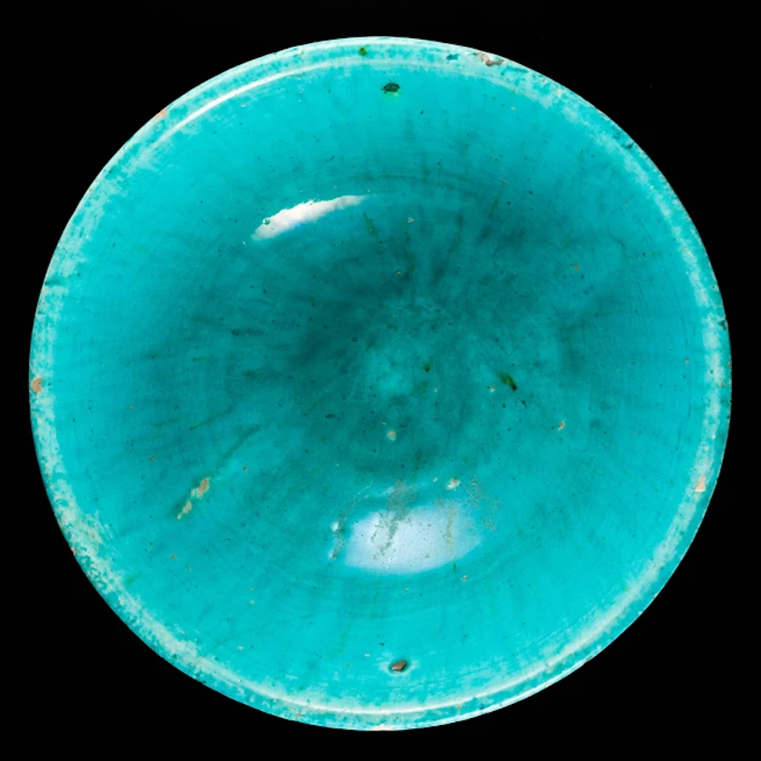 A turquoise glazed pottery bowl