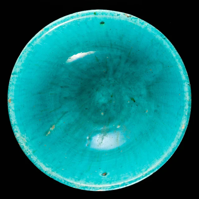 A turquoise glazed pottery bowl
