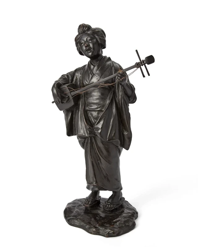 A Japanese bronze figure of bijin 19th century Cast as a...