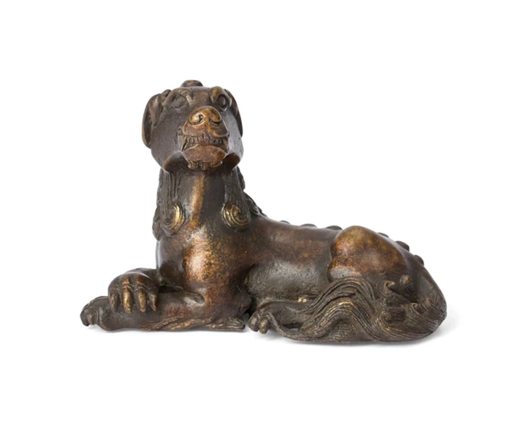 A Chinese bronze recumbent 'mythical beast' paper weight...