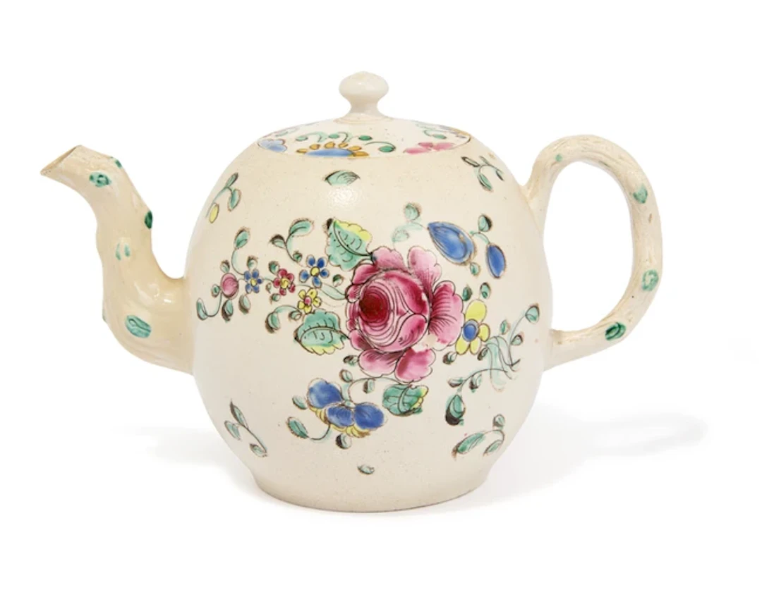 A Staffordshire salt-glazed stoneware teapot and an associated cover