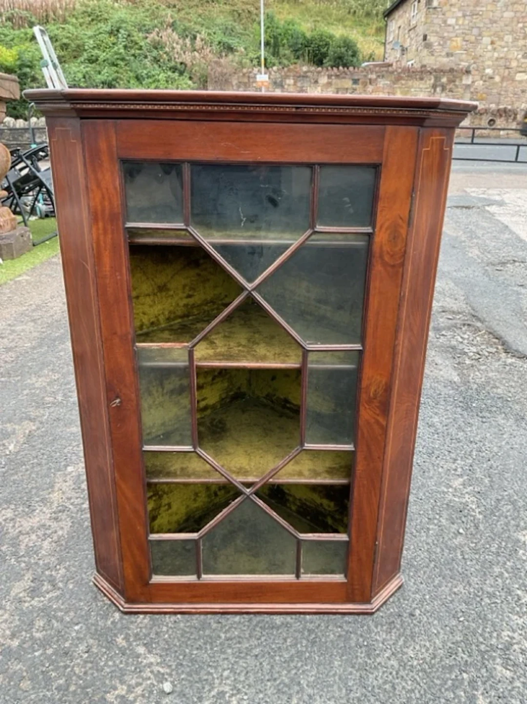 A C19th mahogany corner cabinet with inlaid dentil cornice above an