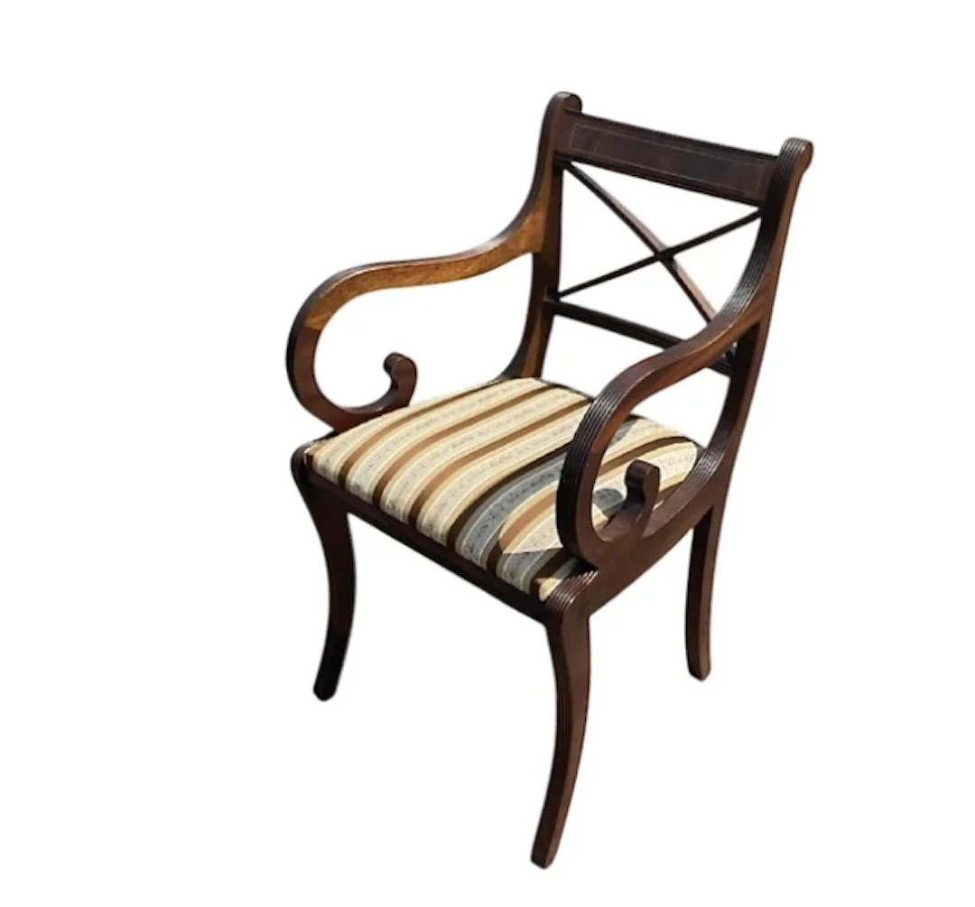 A regency style mahogany armchair with brass strung back above a drop-in