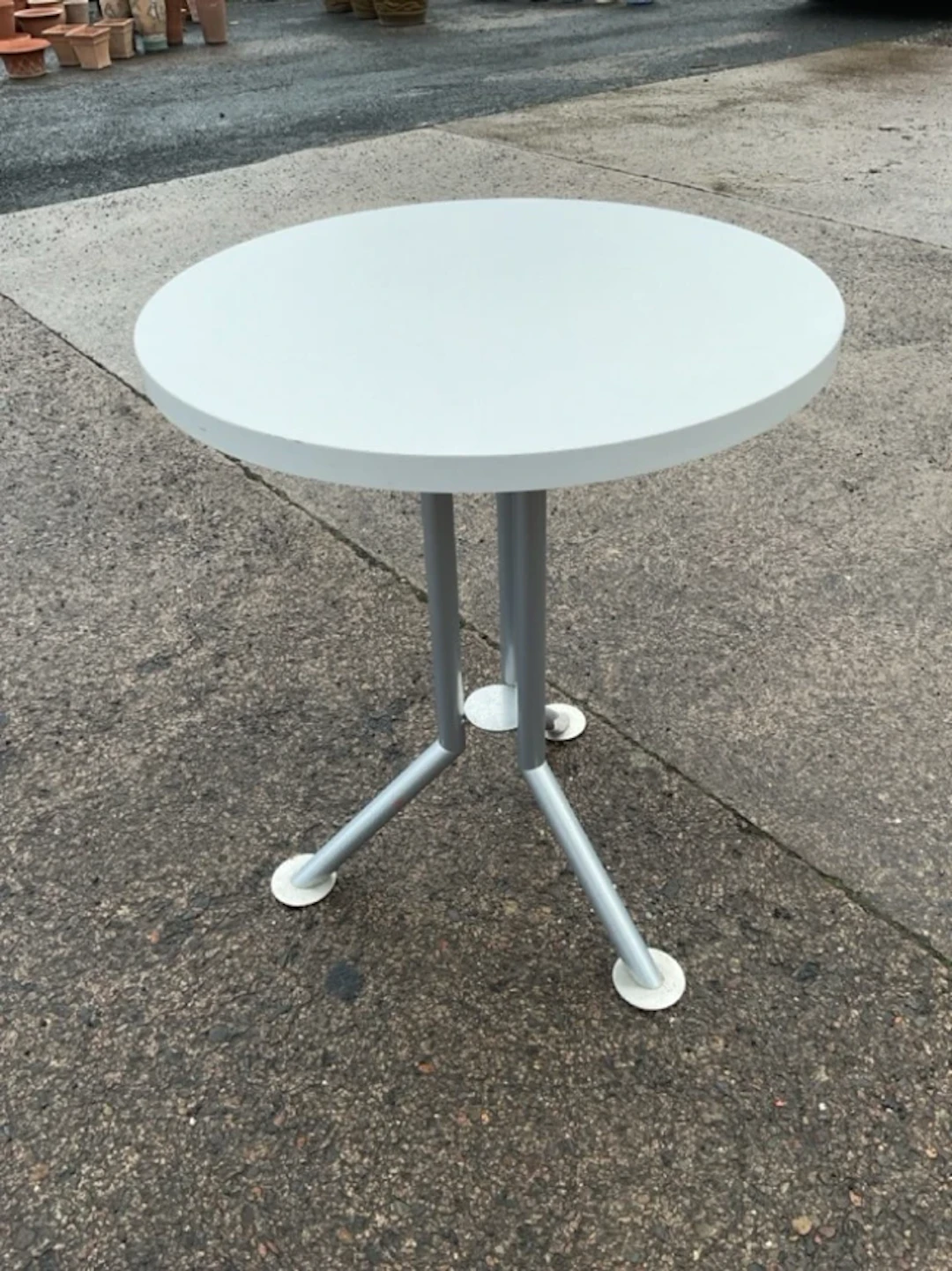 A modern circular occasional table by Bent Krogh, the top on three