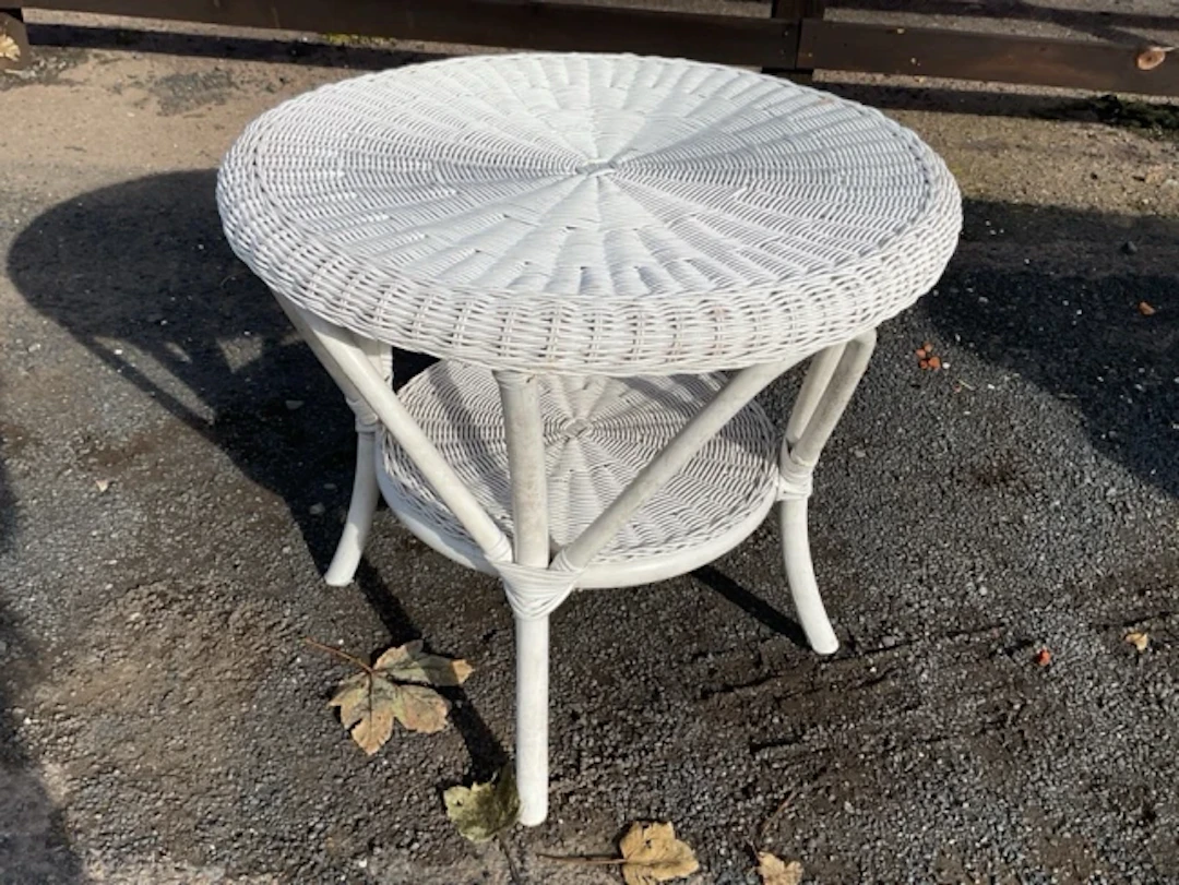 A circular painted cane coffee table on bentwood waisted legs. (24in x 20.5in)