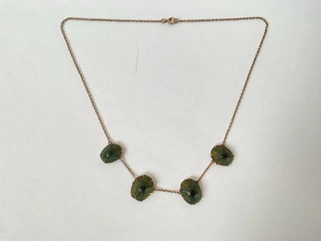 An antique unmarked gold scarab shell necklace, the four casings claw